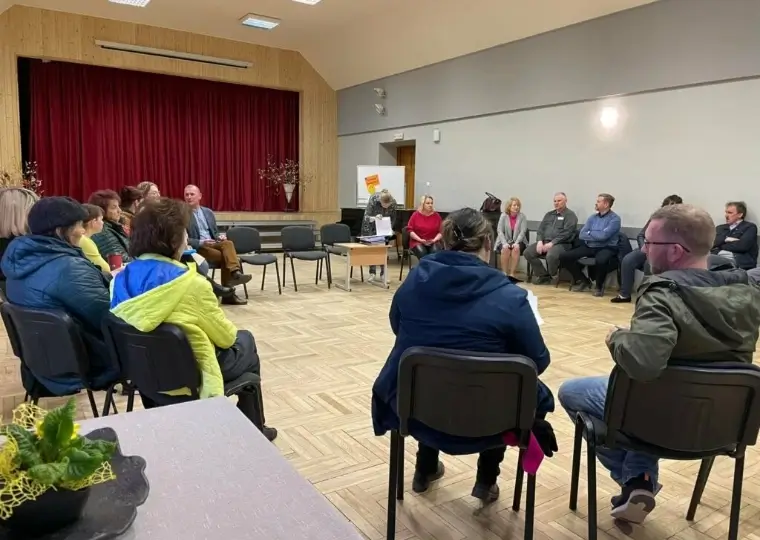 Residents community meeting in a hall, group discussion in a seating circle