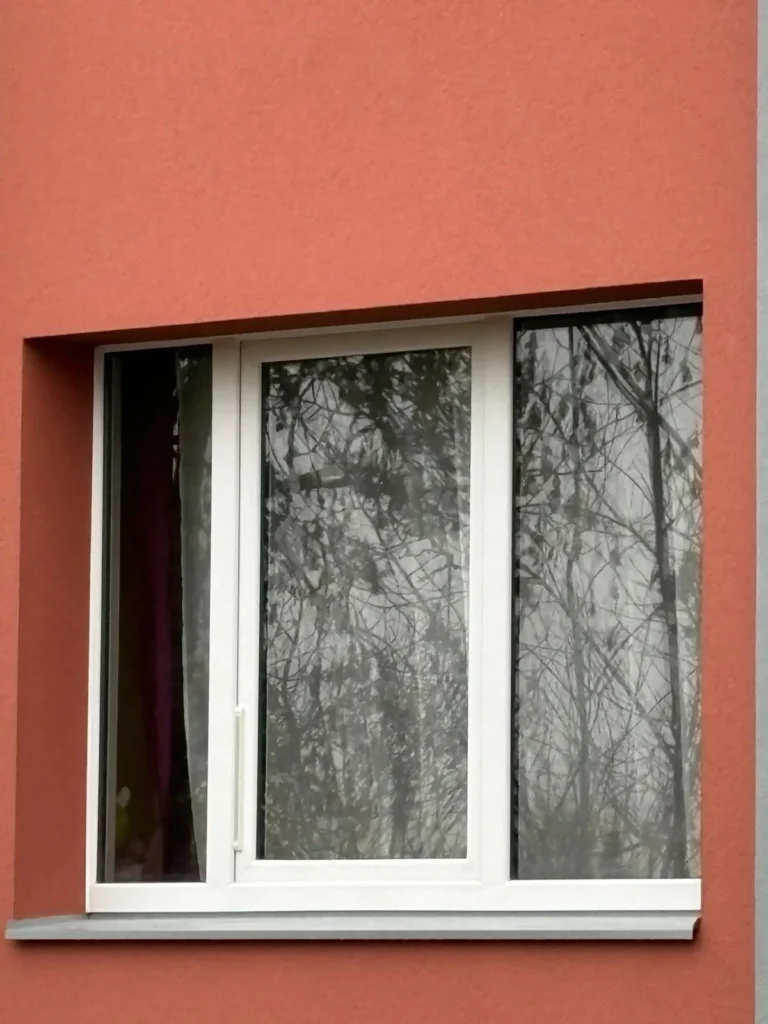 White uPVC windows on an orange facade