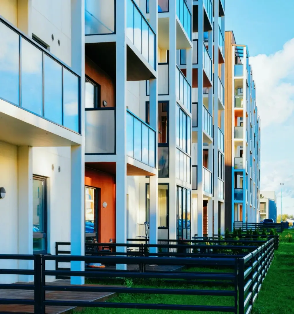 Apartment building facade with glass loggias and balconies, courtyard area