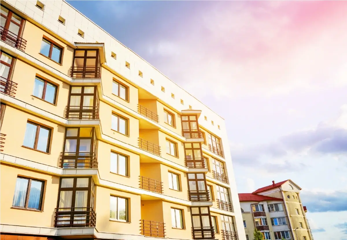 Apartment building with a yellow facade and glazed balconies