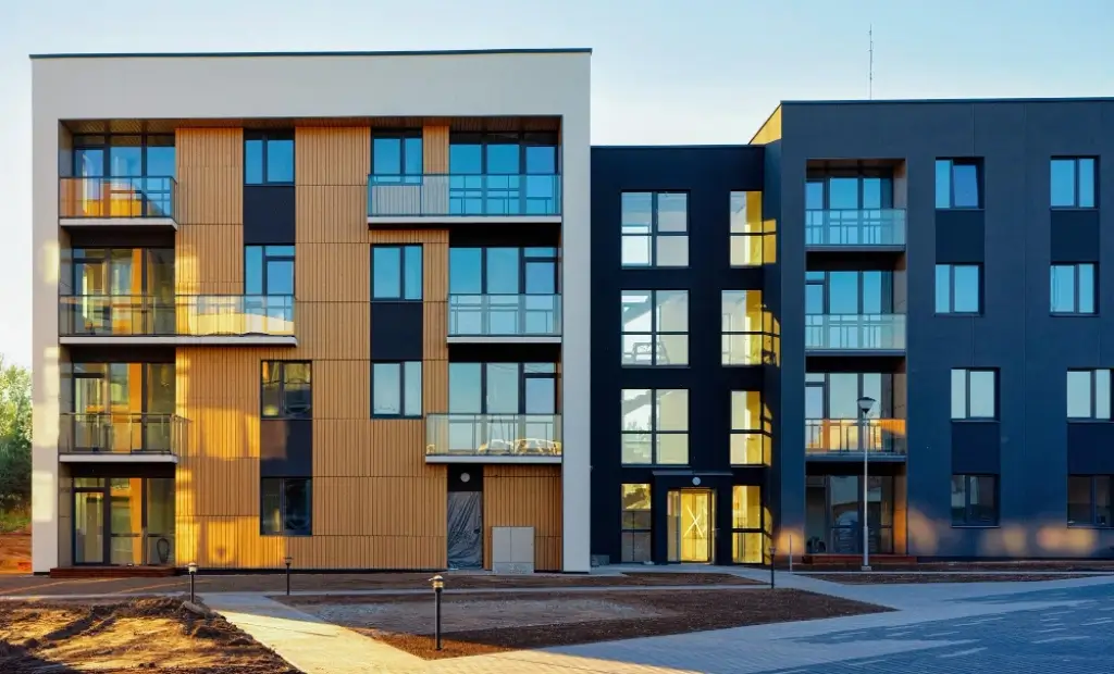 Modern apartment buildings with wood facade cladding and glass balconies