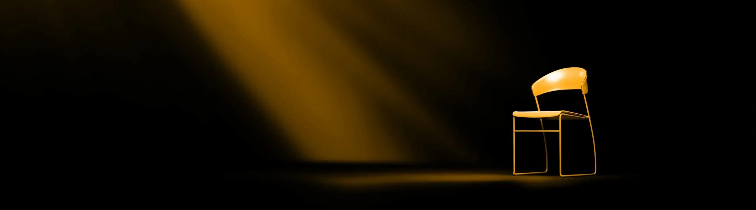 Empty chair on a dark background with stage lighting